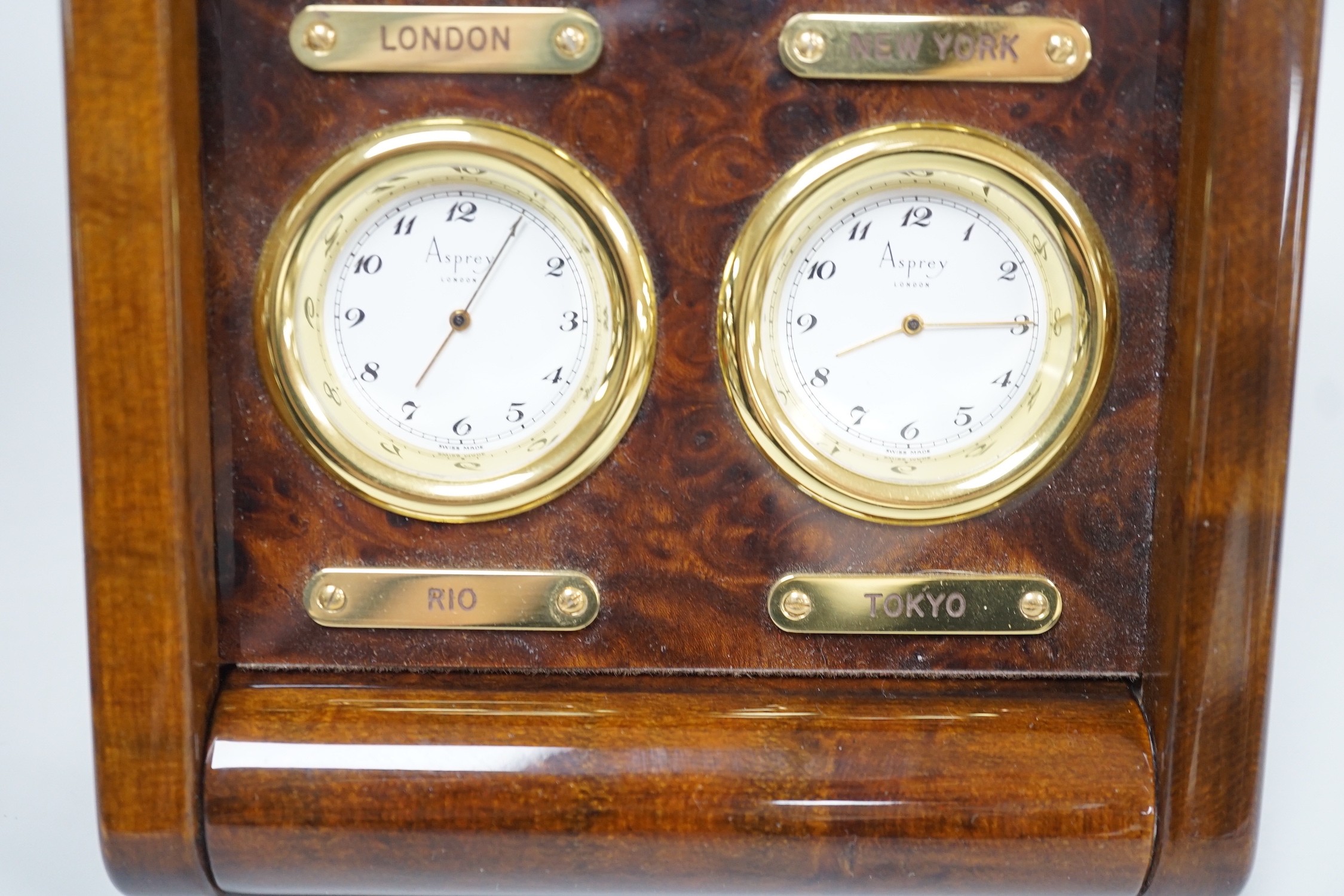 An Asprey burr wood veneered desktop four time zone timepiece, 15.5 cm